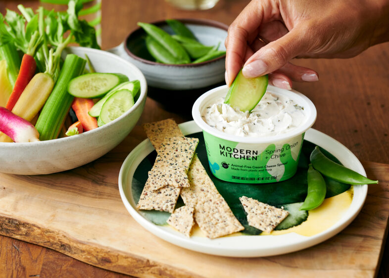 Modern Kitchen hand dipping and vegetables.