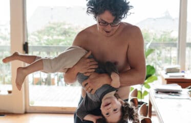 Dad holding child upside down.